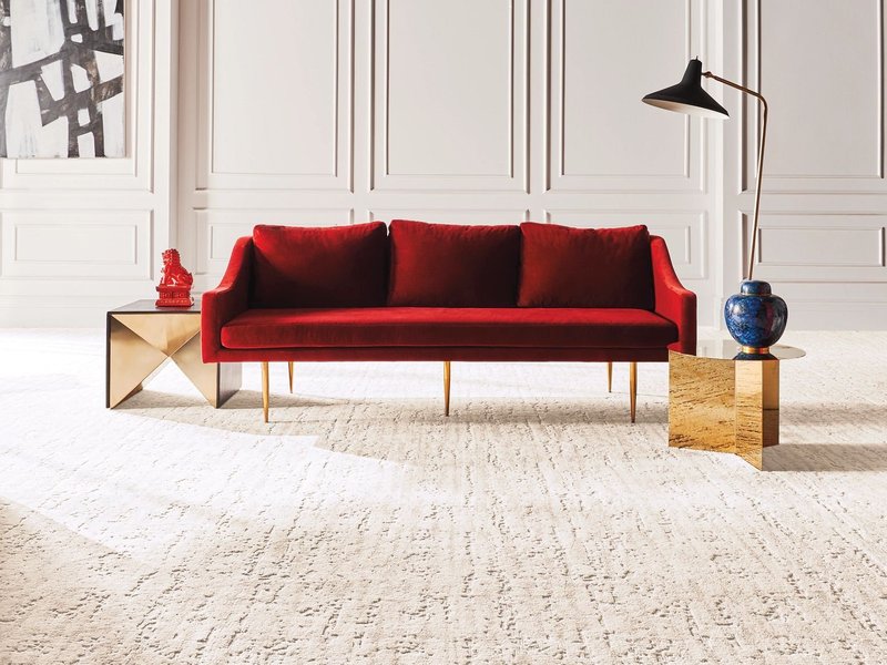 red sofa on a white carpet from U Payless Flooring in Schumacher, ON